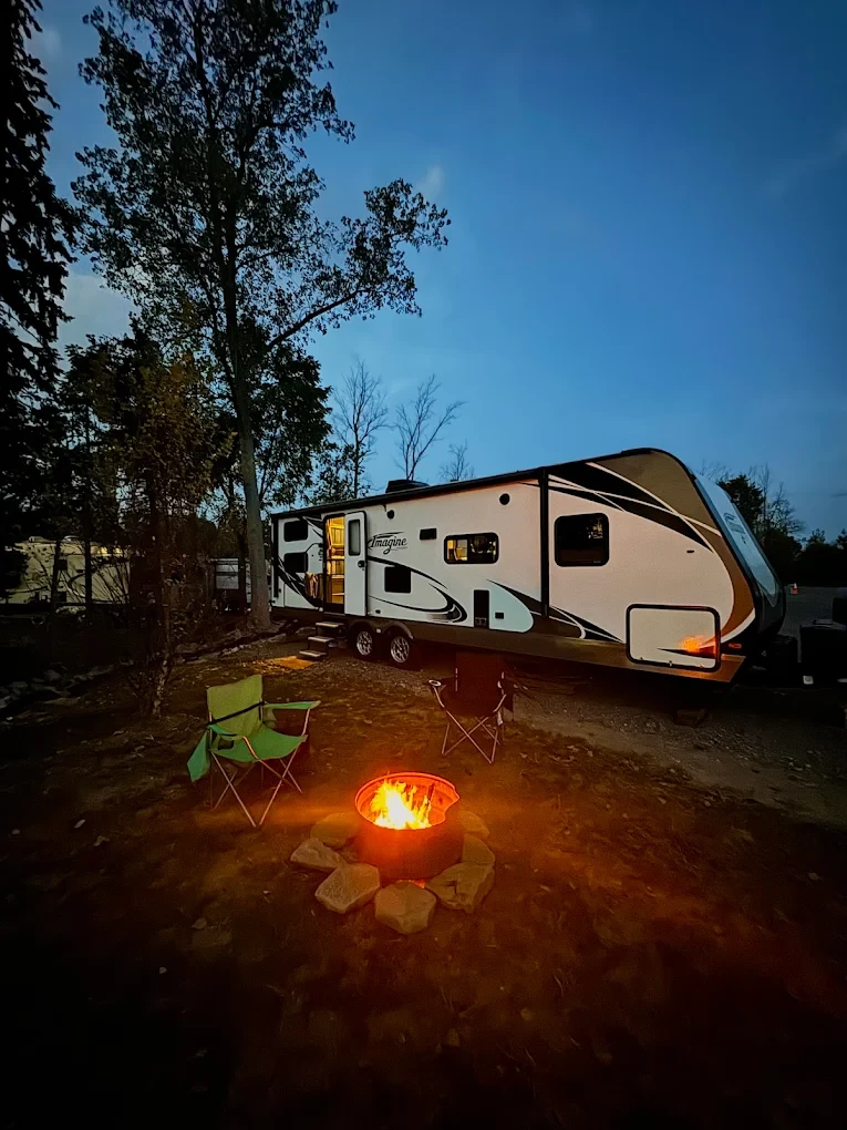 RV site with fire in fire ring evening shot